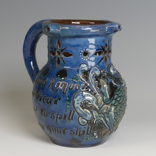 61 - A C. H. Brannam pottery Puzzle Jug, of blue ground decorated with textured paint in white, green and... 