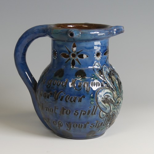 61 - A C. H. Brannam pottery Puzzle Jug, of blue ground decorated with textured paint in white, green and... 