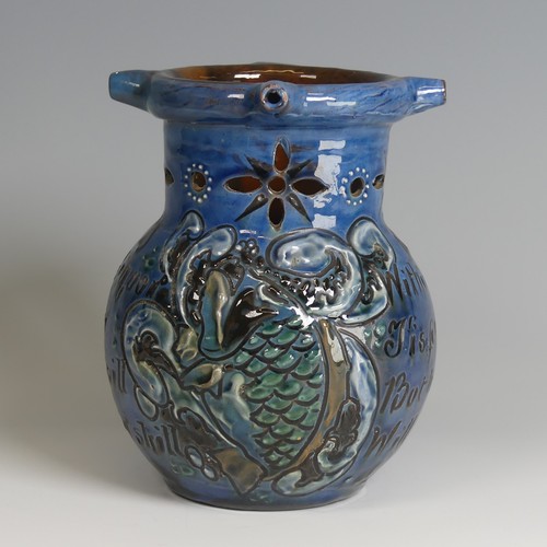 61 - A C. H. Brannam pottery Puzzle Jug, of blue ground decorated with textured paint in white, green and... 