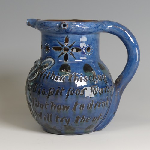 61 - A C. H. Brannam pottery Puzzle Jug, of blue ground decorated with textured paint in white, green and... 