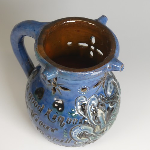 61 - A C. H. Brannam pottery Puzzle Jug, of blue ground decorated with textured paint in white, green and... 