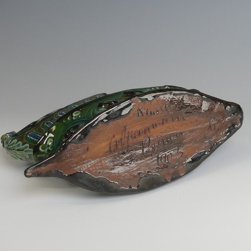 62 - A C. H. Brannam pottery boat shaped flower Trough, with mystical beast figurehead on scrolling waves... 