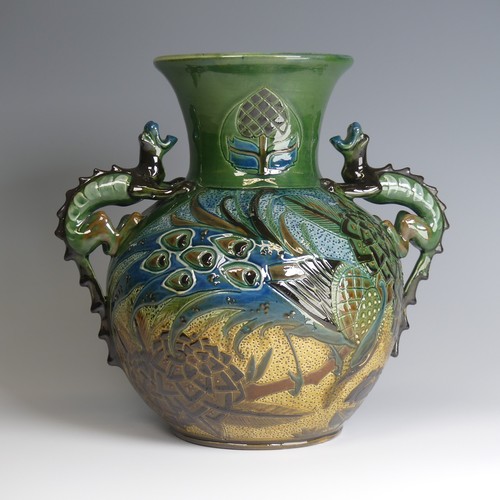 66 - A C. H. Brannam pottery twin-handled Vase, bulbous body with flared rim, decorated with an exotic bi... 