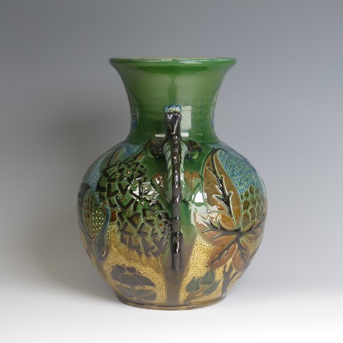 66 - A C. H. Brannam pottery twin-handled Vase, bulbous body with flared rim, decorated with an exotic bi... 