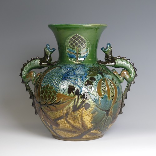 66 - A C. H. Brannam pottery twin-handled Vase, bulbous body with flared rim, decorated with an exotic bi... 