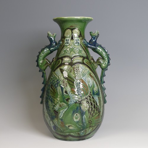 67 - A C. H. Brannam pottery twin-handled Vase, with bulbous body and flared rim, decorated with intertwi... 