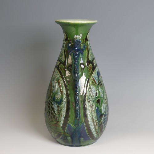 67 - A C. H. Brannam pottery twin-handled Vase, with bulbous body and flared rim, decorated with intertwi... 