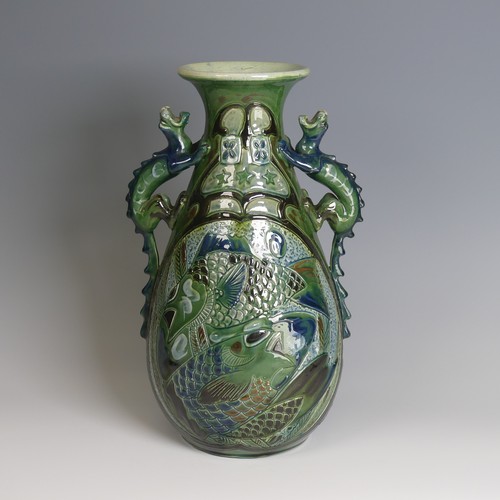 67 - A C. H. Brannam pottery twin-handled Vase, with bulbous body and flared rim, decorated with intertwi... 