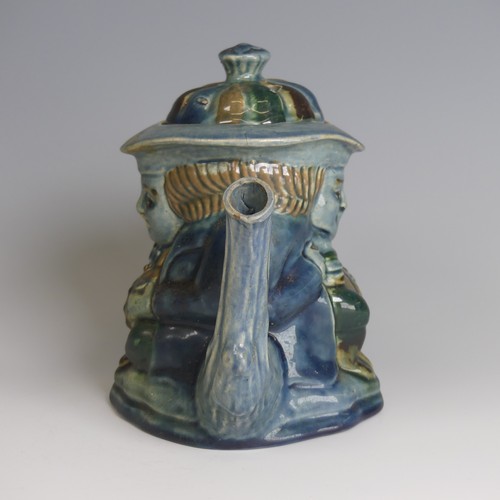 77 - Lauder Barum for Devonia Art Pottery; a character Teapot, modelled as a man holding mug, foliage sha... 