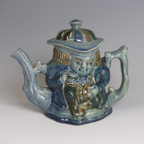 77 - Lauder Barum for Devonia Art Pottery; a character Teapot, modelled as a man holding mug, foliage sha... 