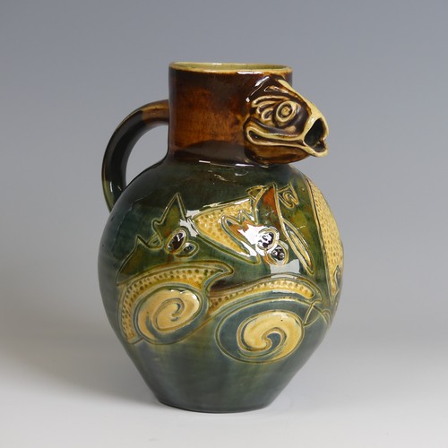 79 - A William Baron pottery fish Jug, with fish mouth for spout, decorated in greens, blues and browns w... 