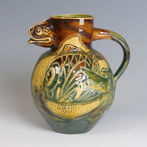 79 - A William Baron pottery fish Jug, with fish mouth for spout, decorated in greens, blues and browns w... 