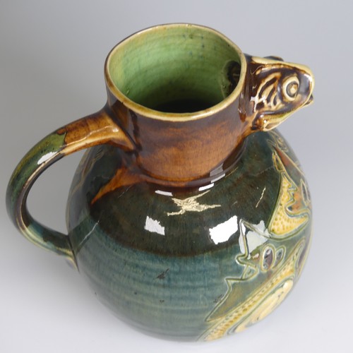 79 - A William Baron pottery fish Jug, with fish mouth for spout, decorated in greens, blues and browns w... 