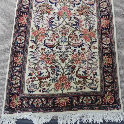 766 - Tribal rugs; a hand-knotted Persian Bidjar runner, cream-ground with traditional design, wool pile o... 