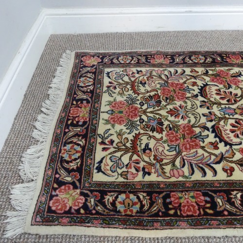 766 - Tribal rugs; a hand-knotted Persian Bidjar runner, cream-ground with traditional design, wool pile o... 