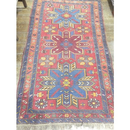 769 - Tribal rugs; a hand-knotted Caucasian Kazak rug, red-ground woven with traditional geometric pattern... 