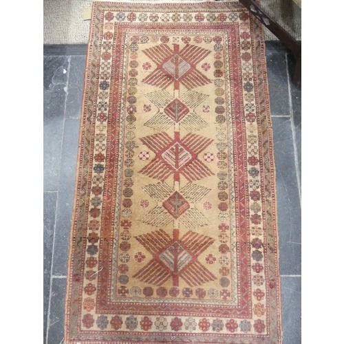 769 - Tribal rugs; a hand-knotted Caucasian Kazak rug, red-ground woven with traditional geometric pattern... 