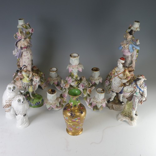 96 - A pair of Sitzendorf porcelain figural Candlesticks, depicting two young figures amongst floral reli... 