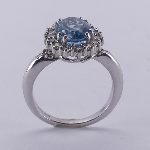  An aquamarine and diamond cluster Ring, the oval facetted aquamarine approx. 9.68mm long, within a s... 