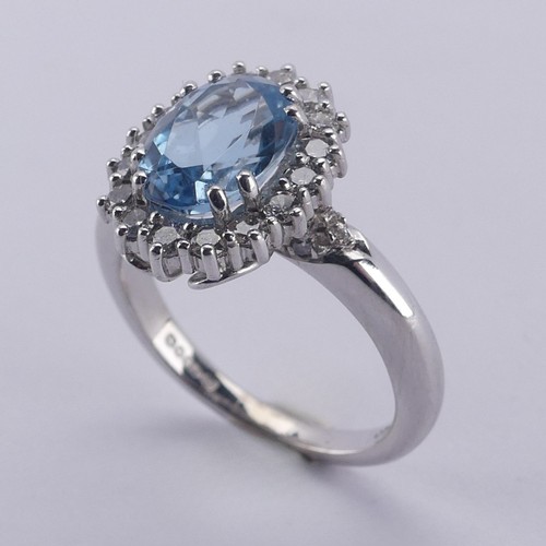  An aquamarine and diamond cluster Ring, the oval facetted aquamarine approx. 9.68mm long, within a s... 