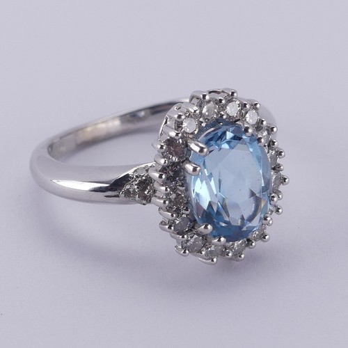  An aquamarine and diamond cluster Ring, the oval facetted aquamarine approx. 9.68mm long, within a s... 