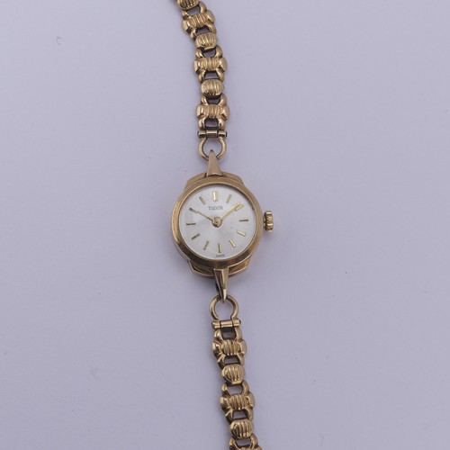 140 - A 9ct yellow gold lady's Tudor Wristwatch, the signed silvered dial with gilt baton markers, Tudor 1... 