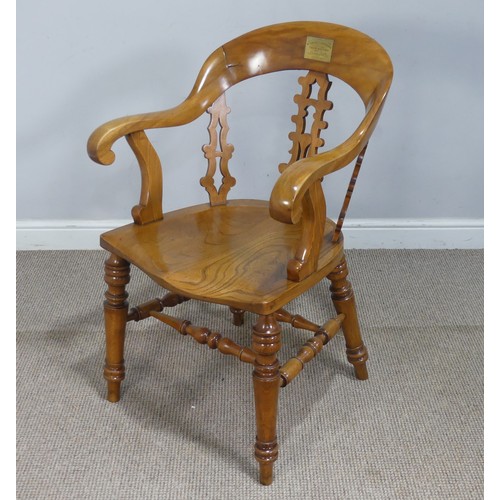 A 19th century beech and elm smokers bow/desk Armchair, the rounded back inset with brass plaque ''Buddugolyn Eisteddfod, Tabor maes-y-bur, Llansamlet, 17th Mai 1880'', terminating to scrolled arms, the central carved and moulded splat flanked by two others of the same design, upon shaped elm saddle seat