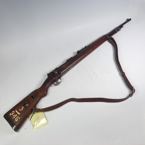 A deactivated German WW2 K98 7.92 Mauser bolt action Rifle, serial number 3959, 24 inch barrel, the receiver bearing Waffenamt stamps, eagle and Swastika stamps and '42' manufacture mark for Mauser, dated 1940, adjustable sights, steel butt plate and mounts, the stock painted 3/346 and with leather sling, L 112 cm.