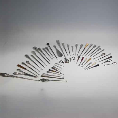 29 - A collection of silver and other base metal Button Hooks, approx. 25 silver mounted, the longest 27.... 
