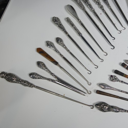 29 - A collection of silver and other base metal Button Hooks, approx. 25 silver mounted, the longest 27.... 