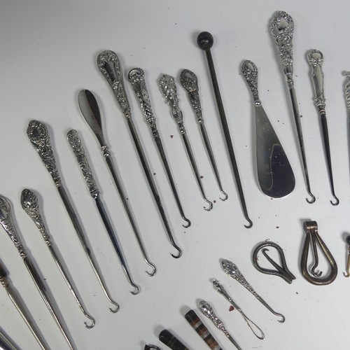 29 - A collection of silver and other base metal Button Hooks, approx. 25 silver mounted, the longest 27.... 