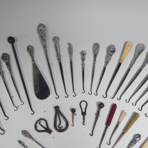 29 - A collection of silver and other base metal Button Hooks, approx. 25 silver mounted, the longest 27.... 