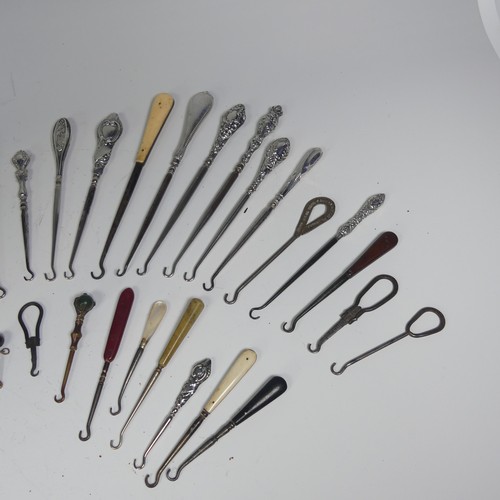 29 - A collection of silver and other base metal Button Hooks, approx. 25 silver mounted, the longest 27.... 