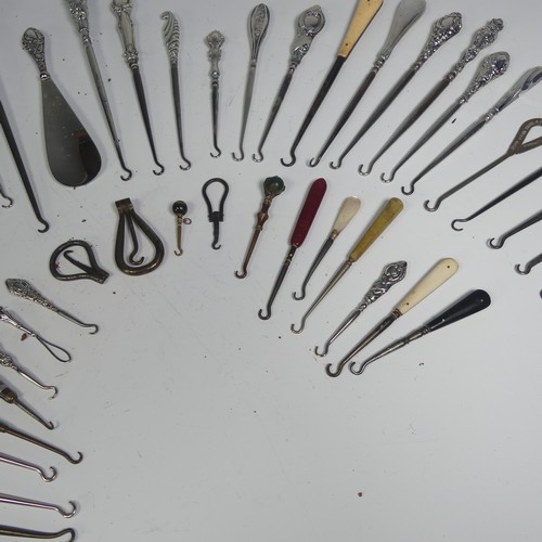29 - A collection of silver and other base metal Button Hooks, approx. 25 silver mounted, the longest 27.... 
