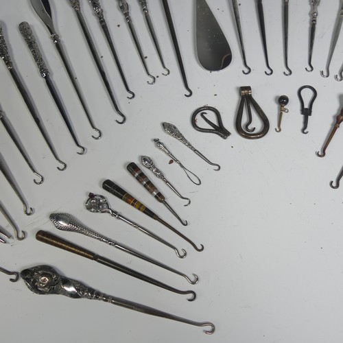 29 - A collection of silver and other base metal Button Hooks, approx. 25 silver mounted, the longest 27.... 
