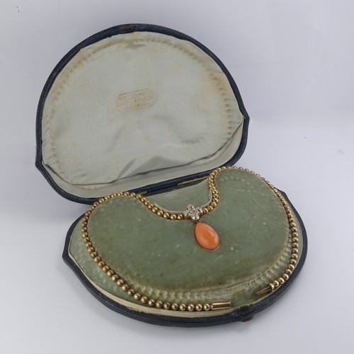 251 - An Edwardian pink coral and diamond Necklace, the pear shaped coral drop with cushion cut diamond cl... 