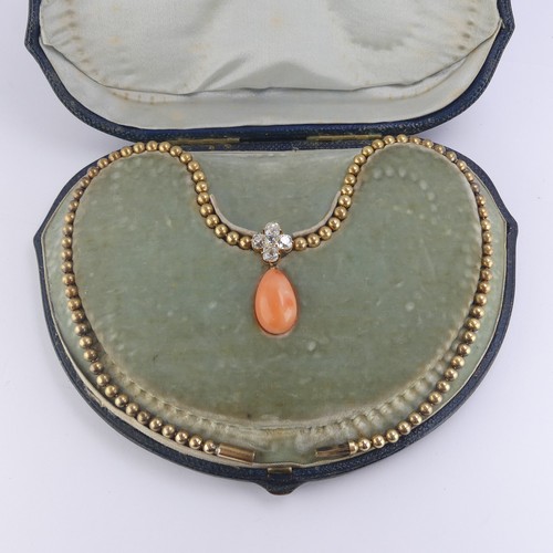 251 - An Edwardian pink coral and diamond Necklace, the pear shaped coral drop with cushion cut diamond cl... 