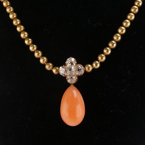 251 - An Edwardian pink coral and diamond Necklace, the pear shaped coral drop with cushion cut diamond cl... 
