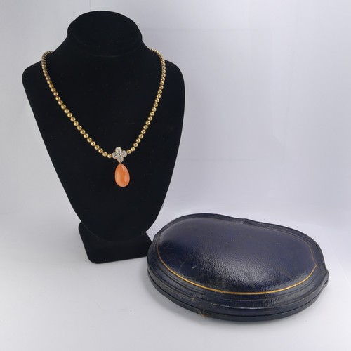 251 - An Edwardian pink coral and diamond Necklace, the pear shaped coral drop with cushion cut diamond cl... 