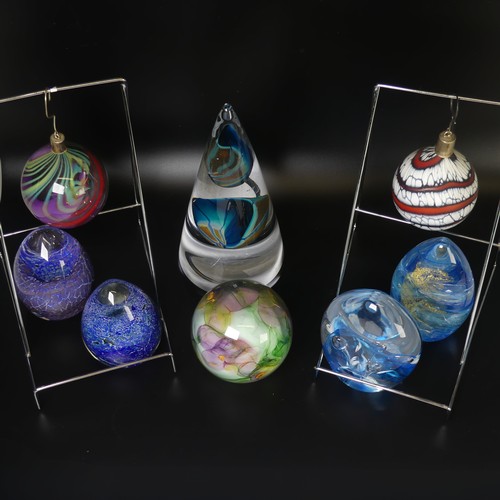 32 - Peter Layton (b. 1937) a studio glass Paperweight, of bullet shape, with light blue swirl and golden... 
