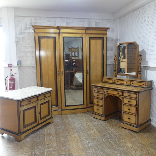 An A W. Taylor & Sons satinwood and oak Aesthetic Movement Bedroom Suite, all pieces with painted geometric pattern, compromising of; a triple Wardrobe, the central door with inset rectangular mirror, opening to reveal a fitted interior of three slides above four drawers, flanked by two cupboards with chamfered geometric outer sides and 'W. Taylor & Sons complete house furnishers, 58A, Brompton Rd. London S.W' on plaque, raised on a plinth base, W 172 cm x H 206 cm x D 58 cm, a matching Dressing Table, with chamfered rectangular bevelled mirror, flanked by turned supports and small drawers, the rectangular top upon a plinth base of small drawers, W 115 cm x H 73 cm x D 55 cm, a matching Chest of Drawers, with marble top, W 91 cm x H 73 cm x D 55 cm. (3)