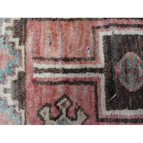 Tribal rugs; a vintage Turkish Herki rug, hand-knotted pale red ground ...