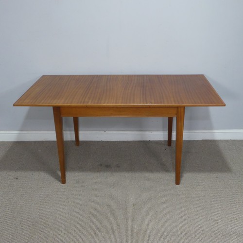 34 - A Mid 20th century Gordon Russell of Broadway teak extending dining Table, raised on tapering suppor... 