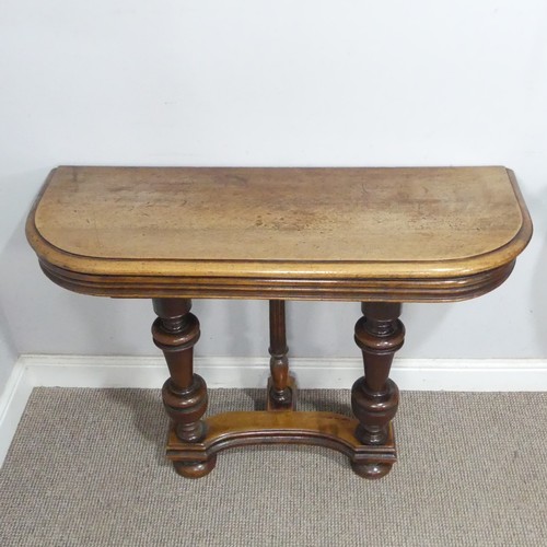 29 - A pair of Victorian mahogany console Tables, the rounded tops raised on turned supports and concave ... 