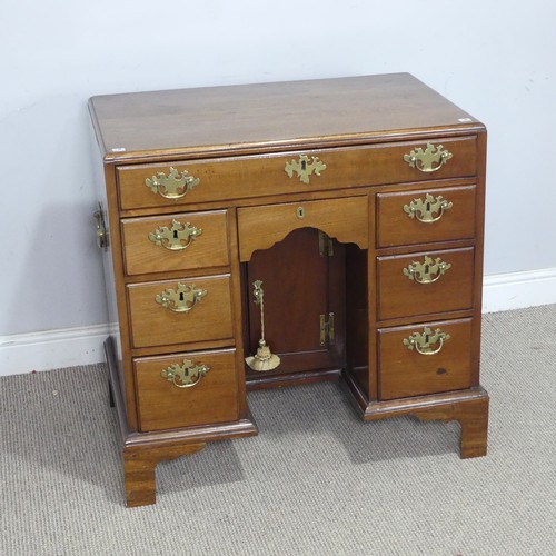 1 - A George III style mahogany kneehole Desk, with carrying handles to each side, and a kneehole cupboa... 
