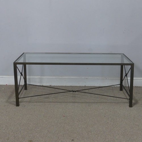 19 - A contemporary glass top coffee Table, with 'zeppelin bend' iron stretchers, W 110 cm x H 42 cm x D ... 
