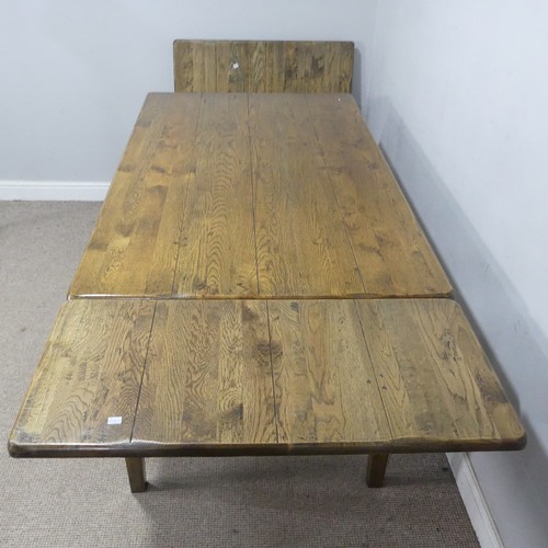 13 - A bespoke antique-style oak dining Table, with two additional leaves, raised on tapering supports, W... 