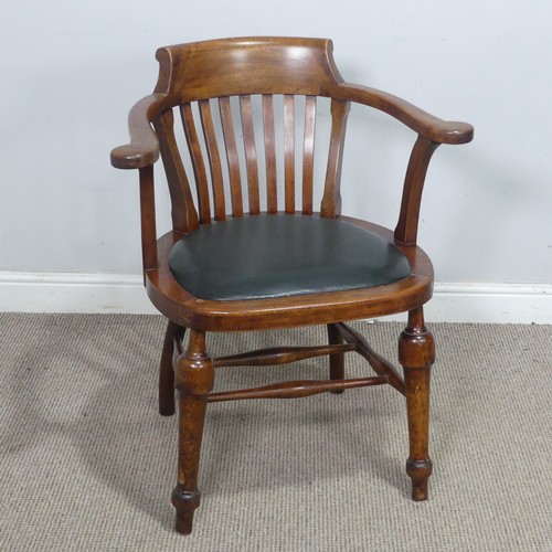 64 - An early 20th century captains-style beech desk Chair, with upholstered seat, the turned supports jo... 