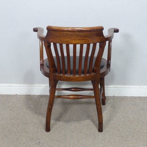 64 - An early 20th century captains-style beech desk Chair, with upholstered seat, the turned supports jo... 