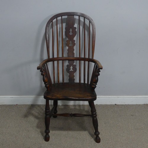121 - A Victorian ash and elm Windsor Armchair, the pierced splat and spindle back above a moulded seat an... 